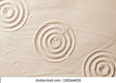 Zen Garden Pattern On Sand As Background, Top View. Meditation And Harmony