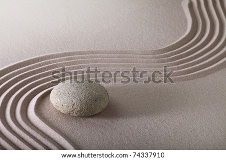 zen garden with raked sand and round stone pattern of ripples and lines create tranquil scene ideal for relaxation and meditation