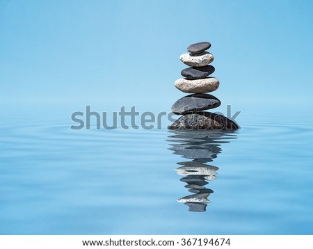Zen meditation relaxation peacefulness peace of mind concept background -  balanced stones stack in water with reflection