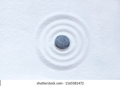 Zen sand circle with the single black stone