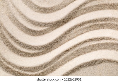 Zen sand garden with raked curved lines. Simplicity, concentration or calmness abstract concept. Top view.