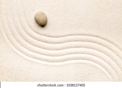 Zen sand and stone garden with raked curved lines. Simplicity, concentration or calmness abstract concept. Top view.