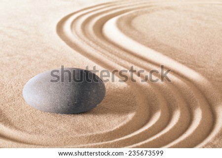 zen stone garden round stone and raked sand making line patterns tranquil scene for relaxation and meditation simplicity and balance are the base of a Japanese garden nice calm spa background 