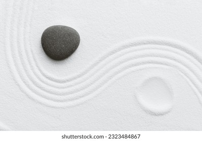 Zen Stone in Japanese garden with grey rock sea stone on white sand texture background, Yin and Yang symbol of dualism in ancient Chinese philosophy.Harmony,Meditation,Zen like concept
