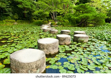 Zen Stone Path In A Japanese Garden Near Heian Shrine.Stones Are Surrounded By Lotus Leaves