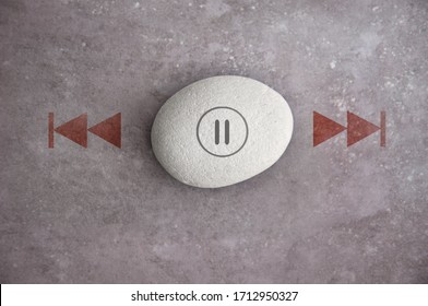 Zen Stone With Pause Symbol, And Fast Forward, Rewind On Either Side 