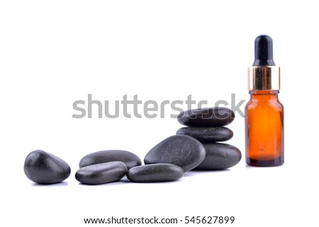 Zen stone with spa oil on white background