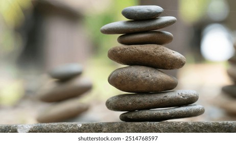 Zen stone stack with blurred background, representing balance, harmony, and tranquility in nature.