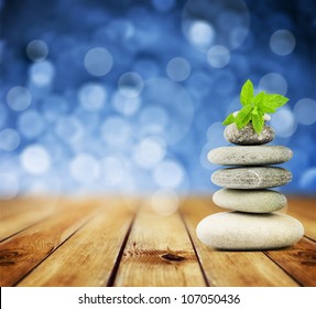 zen stones on the old wood and abstract blue background
