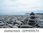 Zen towers on a stony beach. Towers made of pebbles.
