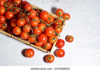 Zenith view. Cherry tomatoes on a tray and stone base, copy space.