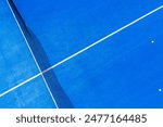 zenithal aerial view from a drone of a blue paddle tennis court