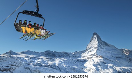 Zermatt, Switzerland - December 7 2019: The Ski Lift Up To Blauherd In The Zermatt Ski Area. Winter In Switzerland. The Matterhorn In The Background. Winter Vacation People.