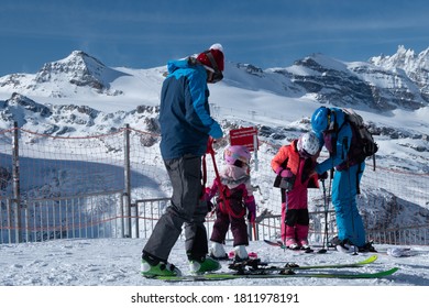 Zermatt, Switzerland - Feb 18 2020: A Family On Skis In The Matterhorn Area. 