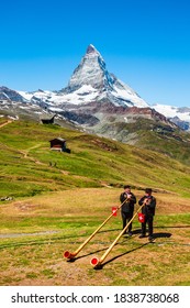 ZERMATT, SWITZERLAND - JULY 16, 2019: Swiss alphorn blowers are playing music near the Matterhorn mountain in the Alps, located between Switzerland and Italy