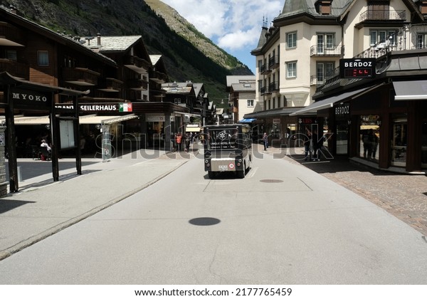 Zermatt, Switzerland-Circa June, 2022: A picture\
of Unique Hotel Post electric vehicle parking at the moving in\
Zermatt Village