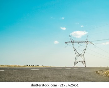 Zero Carbon Emission, Clean Green Energy. High Voltage Power Line In Village Meadows Landscape