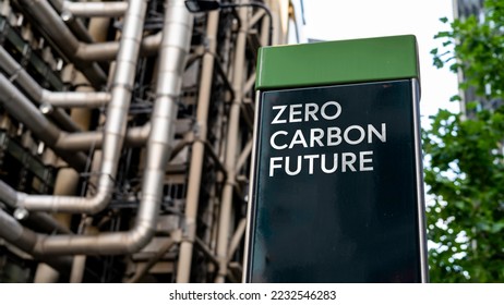 Zero Carbon Future on a sign in front of an Industrial building - Shutterstock ID 2232546283
