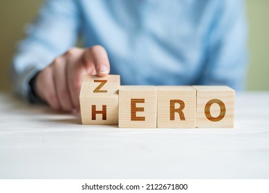 Zero or Hero concept, Hand flip wood cube change the word.women hand flipping cube wooden with text Hero and Zero, Self development and change from loser become to winner concept.