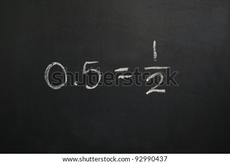 Zero Point Five Equals One Half A horizontal color photograph of a blackboard showing the equation zero point five equals one half.