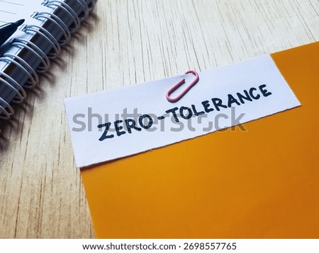 Zero - tolerance writting on table background.
