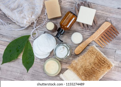 Zero waste bathroom accessories, natural sisal brush, wooden comb, deodorant, shea butter, solid soap and shampoo bars, reusable cotton make up removal pads, make up remover in a glass container. 