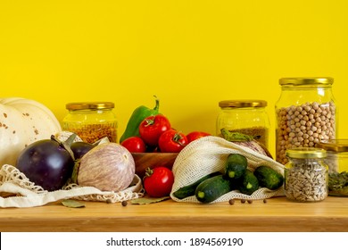 Zero Waste Bio Food Storage And Shopping Concept - Groceries In Textile Bags,glass Jars, Wooden Bowl. Eco Friendly Plastic Free Low Waste Lifestyle. Copy Space Yellow Background.