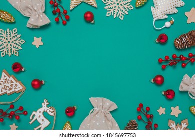 Zero Waste Christmas Composition With Glass, Textile And Wooden Decorations, Pine Cones, Present Bags, Berries On Teal Background. Flat Lay Top View