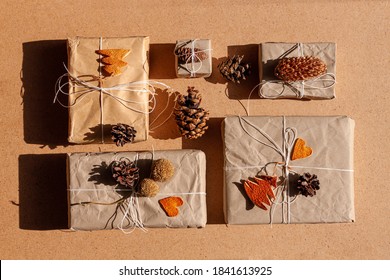 Zero waste Christmas knolling flat lay with hard shadows. Hand crafted eco gift, natural New Year jute decorations top view. Kraft paper wrapping without plastic concept. Orange zest tree,hearts,cones - Powered by Shutterstock