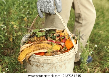 Zero waste, composting, bio waste concept. Farmer with vegetables and fruits food scraps in bucket, compost