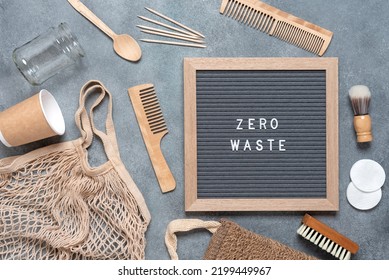 Zero Waste Concept. Bath Accessories And Kitchen Utensils Are Eco-friendly. Zero Waste Text On Letter Board. Gray Concrete Background. Top View, Flat Lay.