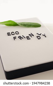 Zero Waste Concept, Pros And Cons. Black Letters On A Peg Board With Message Text Eco Friendly And A Fresh Green Leaf On White Background. Flat Lay.