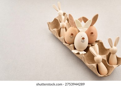 Zero waste Easter. Easter egg bunnies and wooden figures in carton