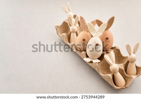 Zero waste Easter. Easter egg bunnies and wooden figures in carton