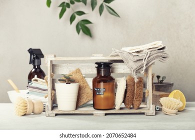 Zero waste home kitchen cleaning concept, front view of dish washing brushes, organic soap bar, kitchen towels, house plant, baking soda, lemon and eco safe all purpose cleaner in reused glass jar - Powered by Shutterstock