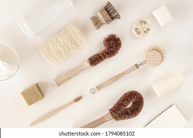 Zero waste kitchen cleaning concept. Eco friendly natural cleaning tools and products, bamboo dish brushes and lemon with baking soda. No plastic, eco-friendly lifestyle. Top view, flat lay.