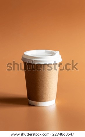 Zero Waste Lifestyle, Craft Disposable Brown Cup with white Plastic Lid on brown background isolated.