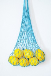 Lemon in a mesh bag. Stock Photo by Maliflower73