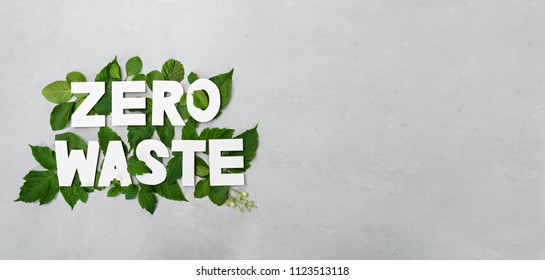 Zero Waste Paper Text Witj Green Leaves On Gray Background 