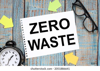 Zero Waste. Sheet Of Paper On A Wooden Blue Background. Next To A Table Clock And Glasses. Business Concept