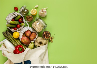 Zero waste shopping concept - groceries in textile bags and glass jars, top view - Shutterstock ID 1402322831
