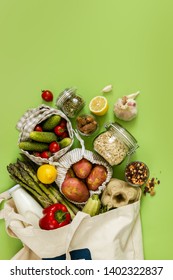 Zero waste shopping concept - groceries in textile bags and glass jars, top view - Shutterstock ID 1402322837