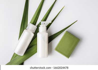 Zero Waste, Sustainable Bathroom And Lifestyle. Natural Soap Bar And Homemade DIY Beauty Products In Reusable Bottles Over White Background.