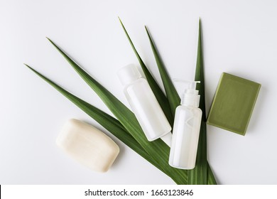 Zero Waste, Sustainable Bathroom And Lifestyle. Natural Soap Bar And Homemade DIY Beauty Products In Reusable Bottles Over White Background.