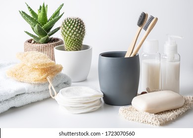 Zero Waste, Sustainable Bathroom And Lifestyle. Bamboo Toothbrush, Natural Soap Bar, Loofah Sponge, Cotton Pads, Homemade DIY Beauty Products In Reusable Bottles Over White Background.