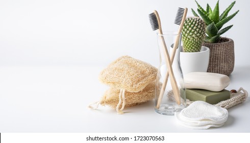 Zero Waste, Sustainable Bathroom And Lifestyle. Bamboo Toothbrush, Natural Soap Bar, Loofah Sponge, Cotton Pads, Homemade DIY Beauty Products In Reusable Bottles Over White Background.