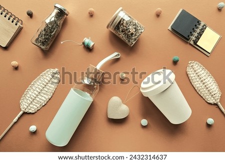 Zero waste tea background, various low impact alternatives to disposable objects in making tea. Geometric arrangement, knolling on brown paper background