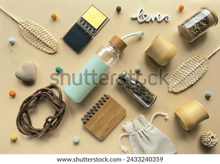 Zero waste tea background, various low impact alternatives to disposable objects in making tea. Geometric arrangement, knolling on pale yellow paper background