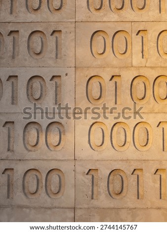 Zeros and ones of binary code are carved as a relief pattern int