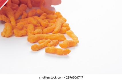 Zesty Cheese Crunchers Spilling Out Of Chip Bag With Copy Space